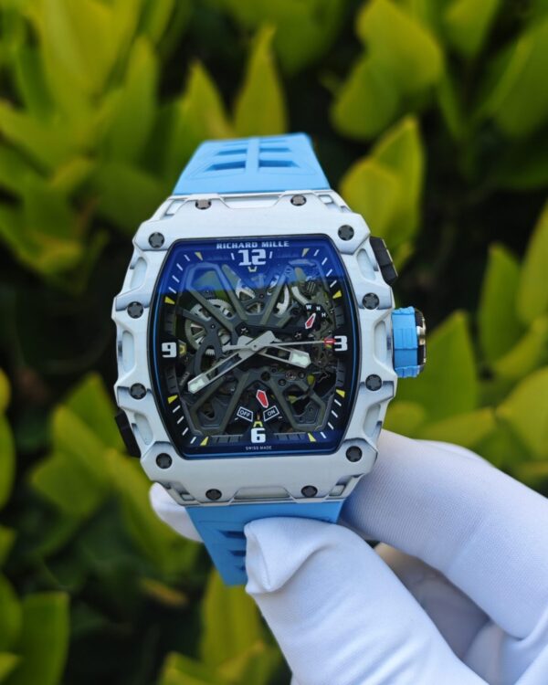 The Richard Mille RM35-03, in white, is equipped with a customized Parmigiani movement. All functions are authentic and operational. It features a deployable butterfly rotor, a customized imported carbon fiber case, and a blue natural rubber strap. — custom-built watch