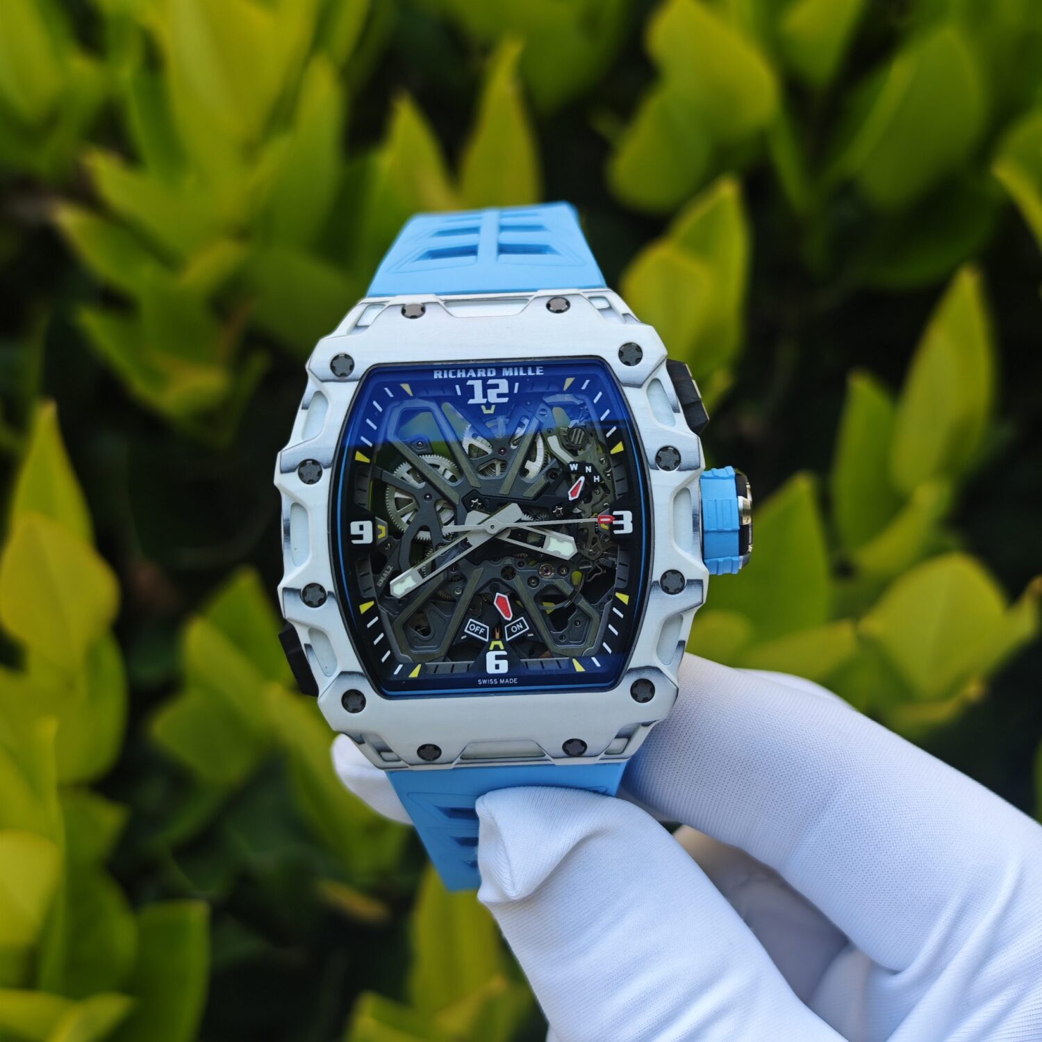 The Richard Mille RM35-03, in white, is equipped with a customized Parmigiani movement. All functions are authentic and operational. It features a deployable butterfly rotor, a customized imported carbon fiber case, and a blue natural rubber strap. — custom-built watch